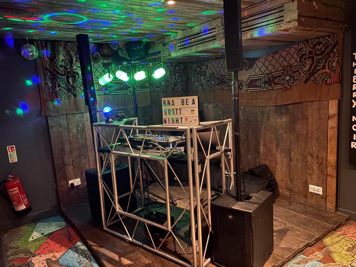 DJ booth and lighting rig in a venue